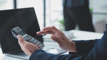 Financial analysts analyze business financial reports on a digital tablet planning investment project during a discussion at a meeting of corporate showing the results of their successful teamwork. video