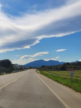 calm landscape of spain with a view of the pyrenees on the horizon and an empty road photo