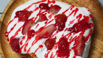 Close-up shot of toasted bread with whipped cream and strawberries. video