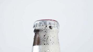 Close-up of an open beer bottle with lots of bubbles coming out of it. video