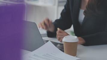 Financial analysts analyze business financial reports on a digital tablet planning investment project during a discussion at a meeting of corporate showing the results of their successful teamwork. video