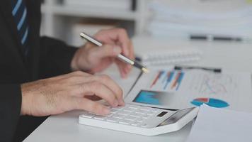 Financial analysts analyze business financial reports on a digital tablet planning investment project during a discussion at a meeting of corporate showing the results of their successful teamwork. video