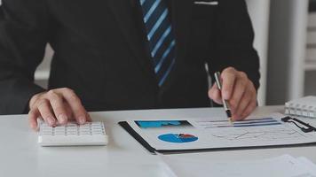 Financial analysts analyze business financial reports on a digital tablet planning investment project during a discussion at a meeting of corporate showing the results of their successful teamwork. video