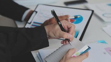 Financial analysts analyze business financial reports on a digital tablet planning investment project during a discussion at a meeting of corporate showing the results of their successful teamwork. video