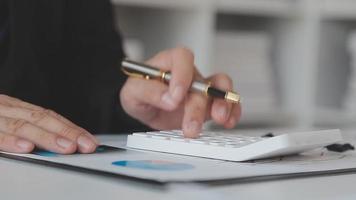 Financial analysts analyze business financial reports on a digital tablet planning investment project during a discussion at a meeting of corporate showing the results of their successful teamwork. video