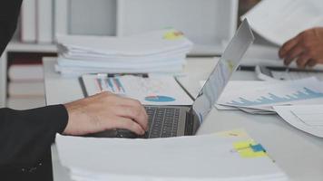 Financial analysts analyze business financial reports on a digital tablet planning investment project during a discussion at a meeting of corporate showing the results of their successful teamwork. video