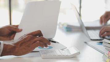 Financial analysts analyze business financial reports on a digital tablet planning investment project during a discussion at a meeting of corporate showing the results of their successful teamwork. video