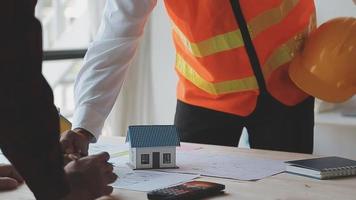 Construction and structure concept of Engineer or architect meeting for project working with partner and engineering tools on model building and blueprint in working site, contract for both companies. video