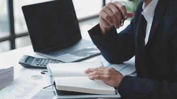 Financial analysts analyze business financial reports on a digital tablet planning investment project during a discussion at a meeting of corporate showing the results of their successful teamwork. video