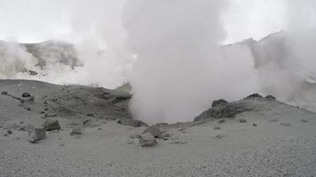 Volcanic activity - boiling thermal mud pot in crater active volcano video