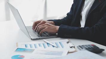 Financial analysts analyze business financial reports on a digital tablet planning investment project during a discussion at a meeting of corporate showing the results of their successful teamwork. video