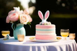 Easter cake decorated with flowers and bunny ears on a white table photo