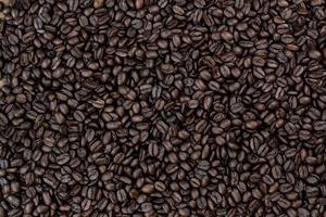 Top view background of aromatic brown coffee beans scattered on surface photo