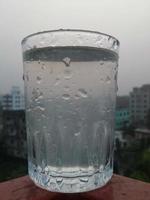 Glass of clear cold water is full photo