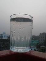 Glass of clear cold water is full photo