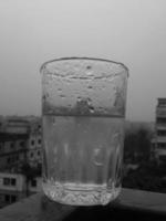 Glass of clear cold water is half full photo