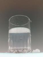 Glass of clear cold water is half full photo