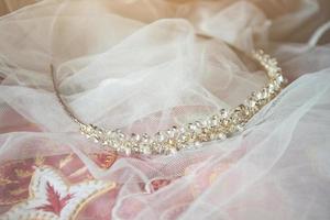 Beautiful crystal diadem on white vail of bride on vintage chair in wedding ceremony. Valentine day photo