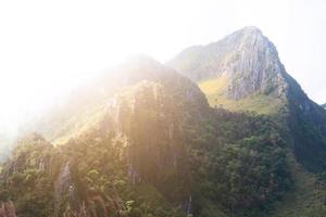 Beautiful sunset on rocky Limestone Mountain and green forest with blu sky at Chiang doa national park in Chiangmai, Thailand photo