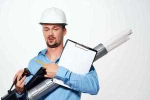 man in a construction helmet blueprints documents work engineer photo