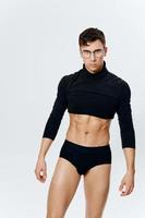 sporty man with pumped up torso in shorts and black sweater cropped view photo