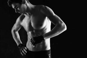 man with a pumped-up torso workout exercise sport dark background photo