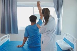 Physiotherapist working with patient in clinic, closeup photo