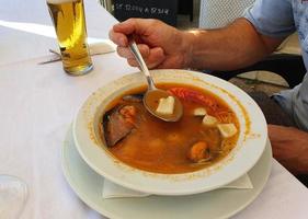 healthy traditional fish soup with seafood in a restaurant in spain photo