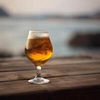 A beer glass on a wooden table photo