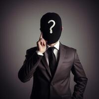 A man with a black suit with question mark instead photo