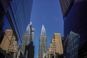 new york manhattan skyscrapers view from the street to the top of the building on sunny clear day photo