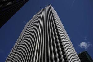 new york manhattan skyscrapers view from the street to the top of the building on sunny clear day photo