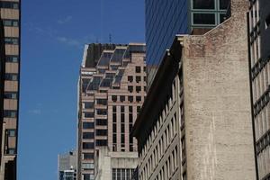 new york manhattan skyscrapers view from the street to the top of the building on sunny clear day photo