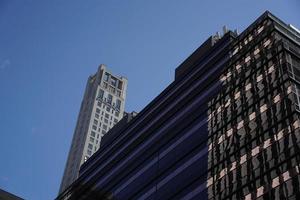 new york manhattan skyscrapers view from the street to the top of the building on sunny clear day photo