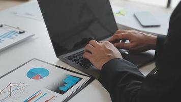 Financial analysts analyze business financial reports on a digital tablet planning investment project during a discussion at a meeting of corporate showing the results of their successful teamwork. video