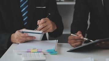 Financial analysts analyze business financial reports on a digital tablet planning investment project during a discussion at a meeting of corporate showing the results of their successful teamwork. video