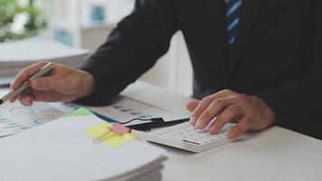 Financial analysts analyze business financial reports on a digital tablet planning investment project during a discussion at a meeting of corporate showing the results of their successful teamwork. video
