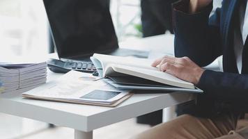 Financial analysts analyze business financial reports on a digital tablet planning investment project during a discussion at a meeting of corporate showing the results of their successful teamwork. video