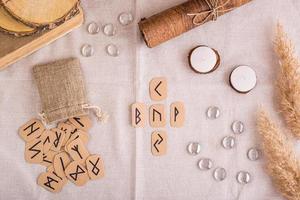 Divination by a cross on homemade Scandinavian runes on the table top view photo