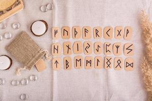 A set of homemade runes made of cardboard lies in rows on the table top view photo