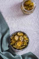 Spicy mexican pickled jalapeno peppers in bowl and glass jar top and vertical view photo