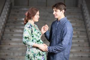 A pregnant woman with her husband hold each other's hand. photo