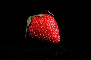 Strawberries on black background photo