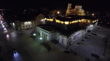 The view made with a drone over the center of the capital at the building of the National Assembly and the monument to St. Alexander Nevsky at night video