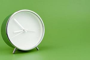 alarm clock on green background time concept working with time precious time photo