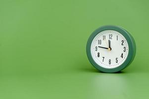 alarm clock on green background time concept working with time precious time photo