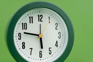 alarm clock on green background time concept working with time precious time photo