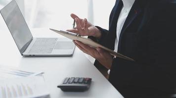 Financial analysts analyze business financial reports on a digital tablet planning investment project during a discussion at a meeting of corporate showing the results of their successful teamwork. video