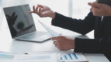 Financial analysts analyze business financial reports on a digital tablet planning investment project during a discussion at a meeting of corporate showing the results of their successful teamwork. video