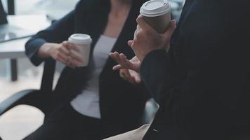 Financial analysts analyze business financial reports on a digital tablet planning investment project during a discussion at a meeting of corporate showing the results of their successful teamwork. video